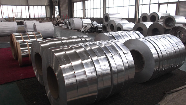 Aluminium coils and slit strip coils stocked on a warehouse floor